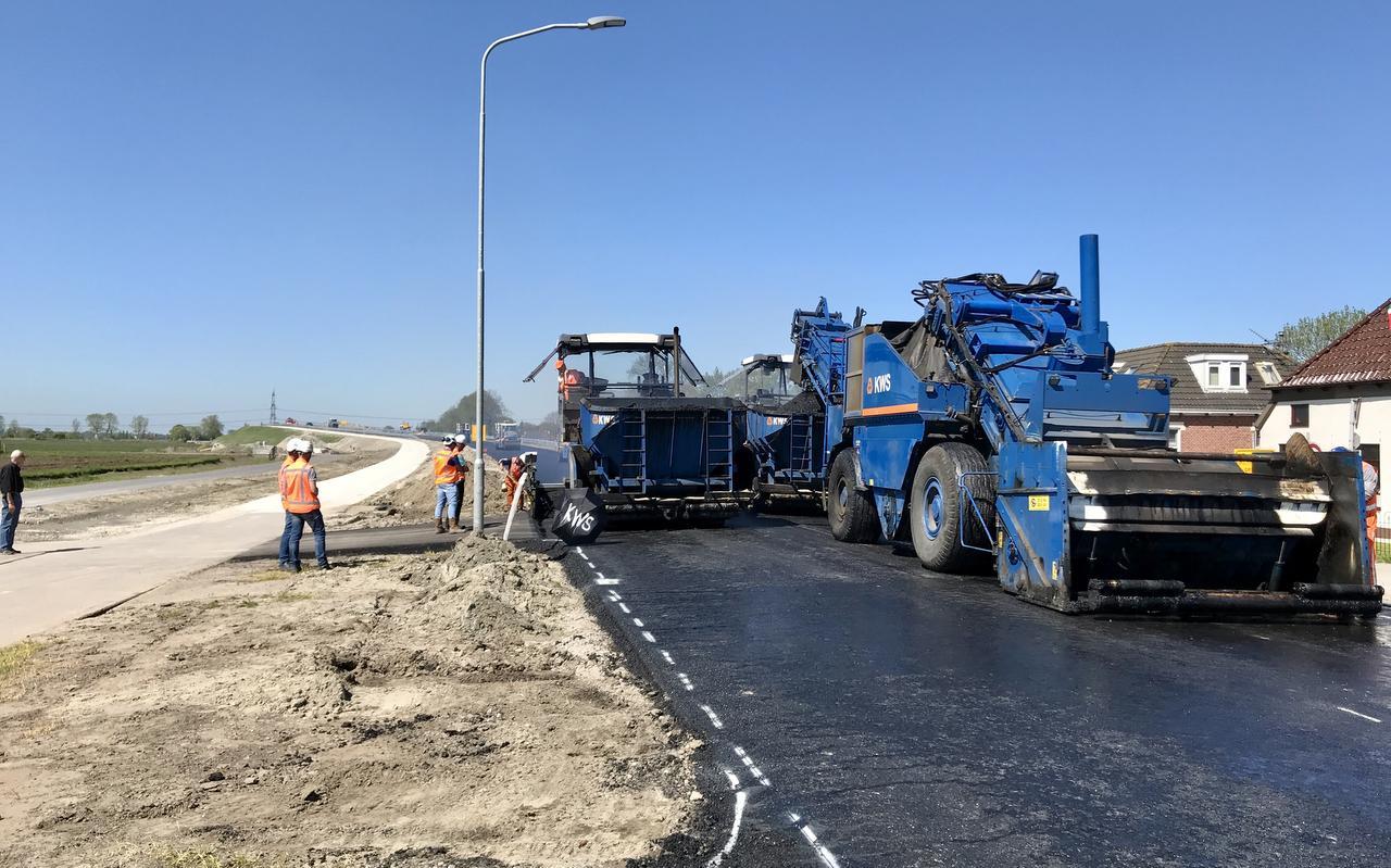 Wegenbouwers leggen de laatste hand aan een wegdek. Foto: Archief DVHN Wegenbouwers leggen de laatste hand aan een wegdek. Foto: Archief DVHN