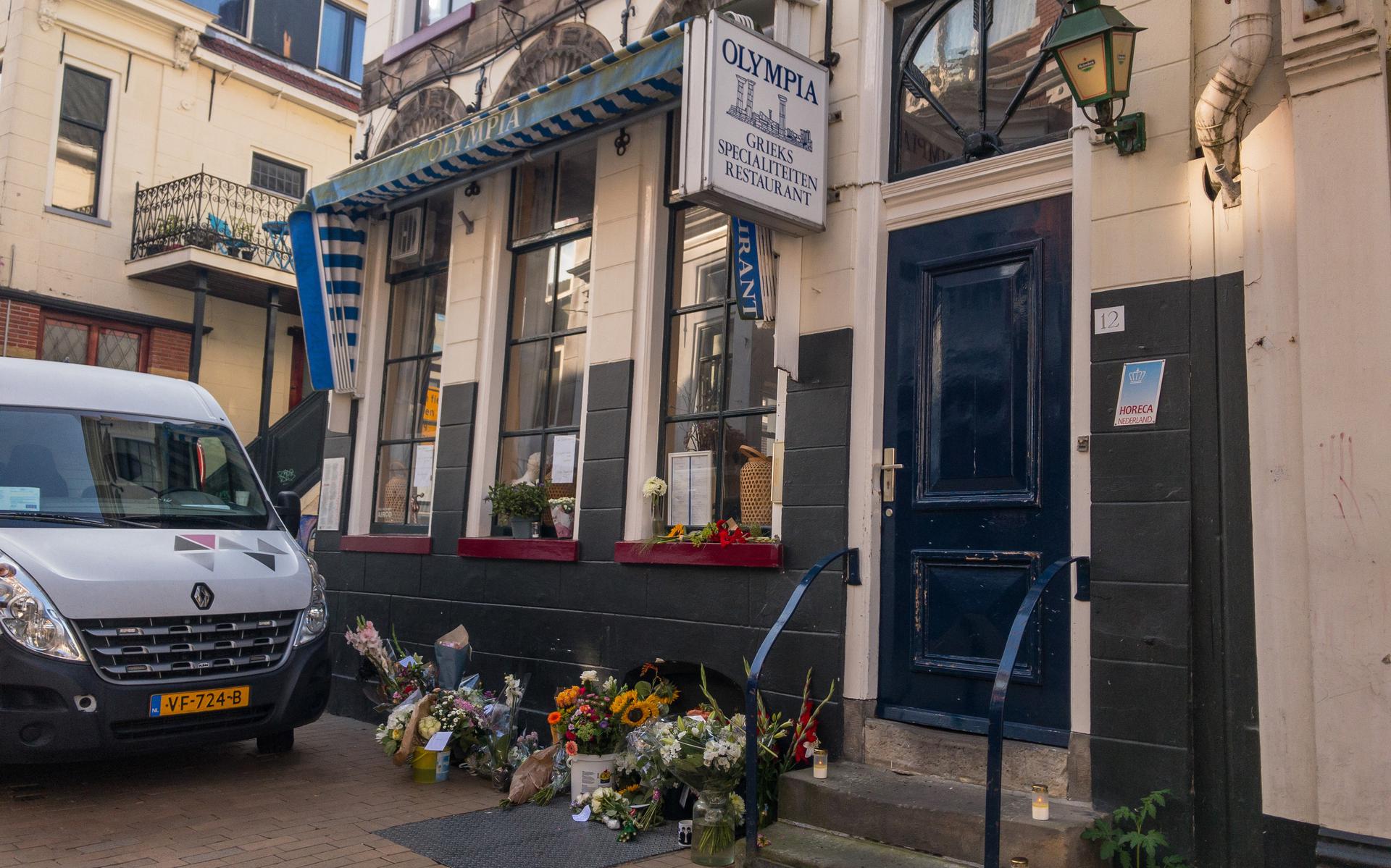Bij het restaurant van het slachtoffer werden bloemen gelgd. De mannen die verdacht worden van betrokkenheid bij zijn dood blijven vastzitten.