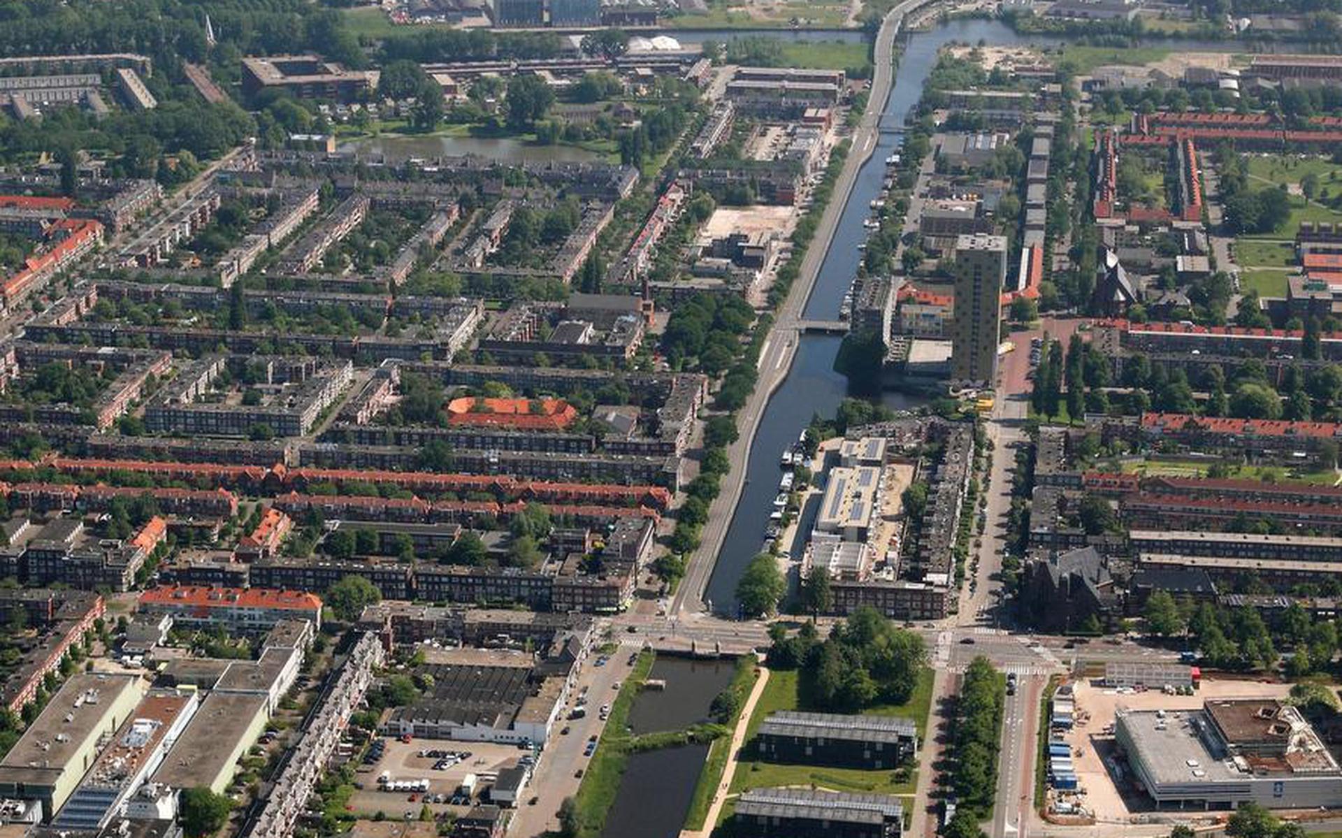 Luchtfoto van het Oosterhamriktracé met DOT aan de Vrydemalaan (rechts) vooraan. Auto’s rijden straks, als het aan B en W ligt, langs het water naar de ringweg, bussen door de Oosterparkwijk in het verlengde van de Vrydemalaan. Foto Aerophoto Eelde
