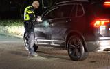 Een agent controleert een auto die de wijk Poppenhare in Coevorden in wil.