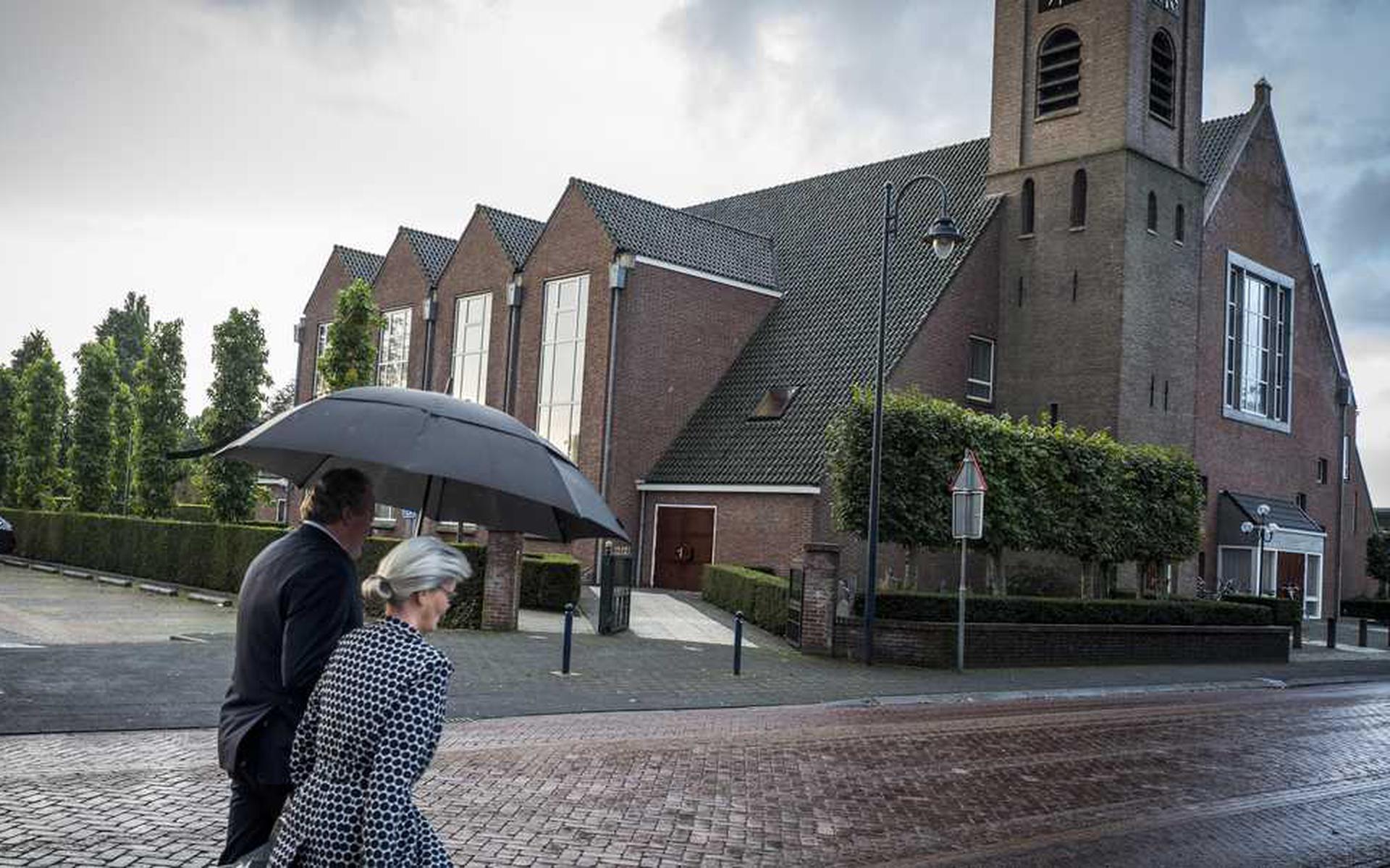 Kerkgangers komen aan bij de Hersteld Hervormde Kerk in het  Staphorst