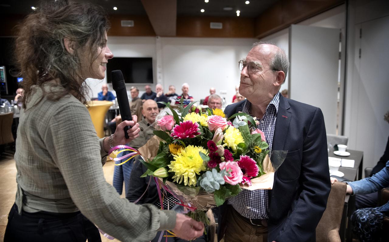 De scheidende GBB-voorzitter Jelle van der Knoop krijgt bloemen van secretaris Merel Jonkheid.