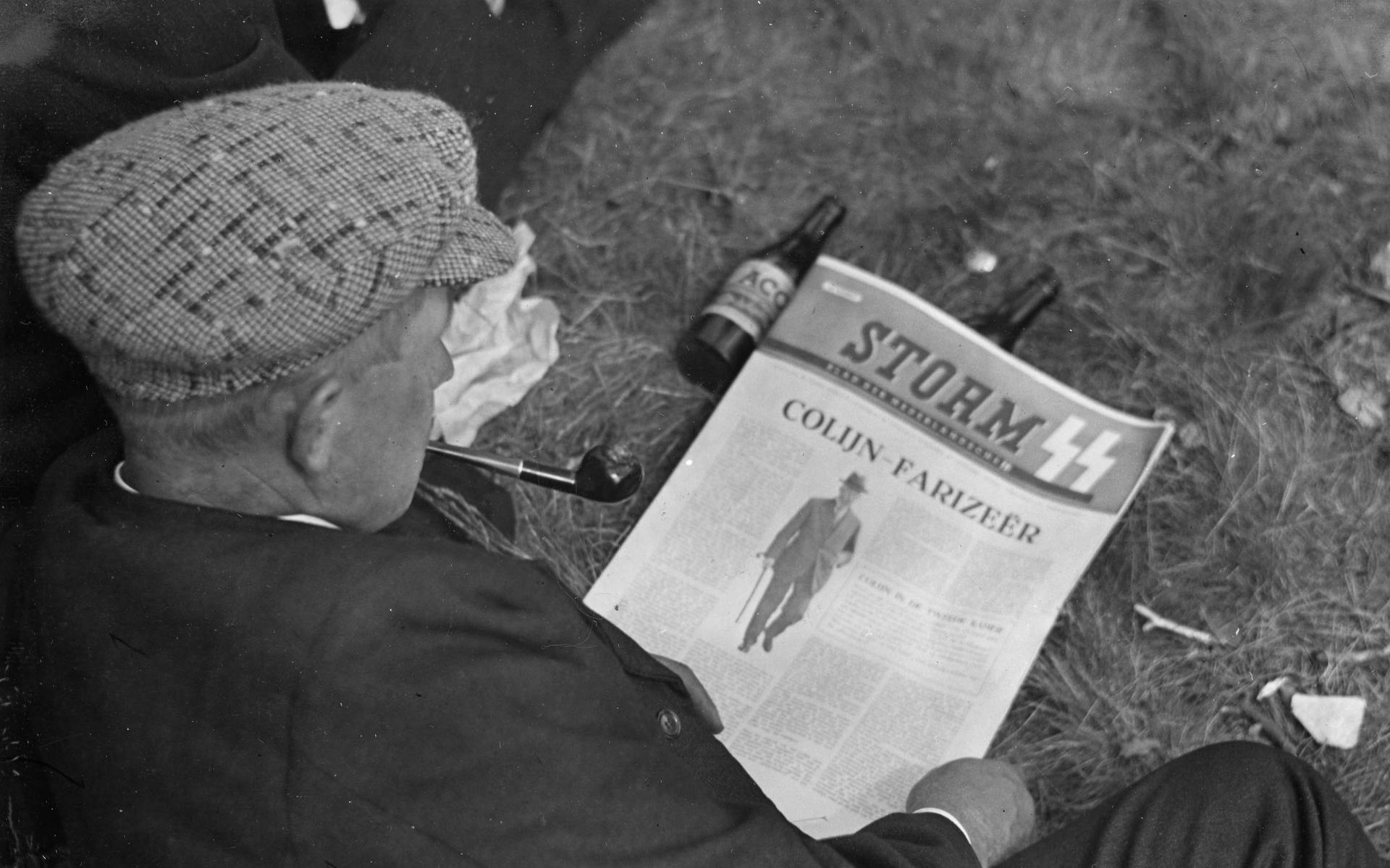 Een man leest op 5 juli 1941 in Rolde een artikel over oud-premier Hendrikus Colijn in Storm, het weekblad van de Nederlandse SS.