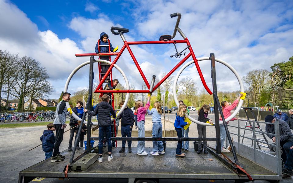 Voor de start van de inschrijving in Westerbork is het symbool van de Fiets4Daagse, een joekel van een fiets uit de mottenballen gehaald . Basisschoolleerlingen poetsen de fiets weer op.