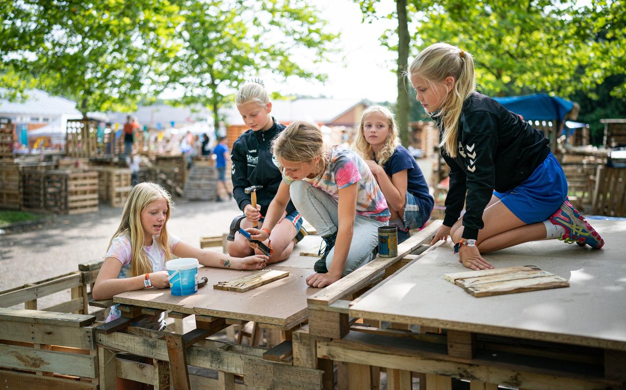 Een groepje kinderen is druk bezig met het bouwen van een hut in het Kinderdorp Zuidlaren. Een groepje kinderen is druk bezig met het bouwen van een hut in het Kinderdorp Zuidlaren.