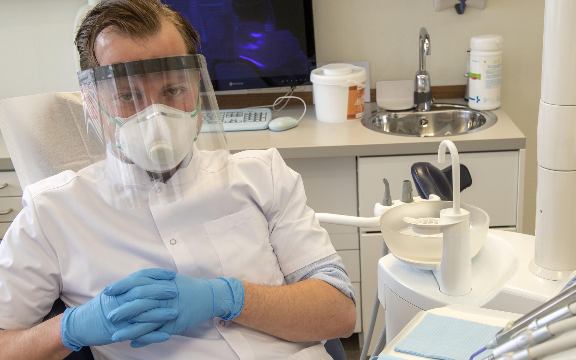 Bouwe Vastenburg wapent zich met mondkapje en plastic spatmasker tegen besmetting van corona.