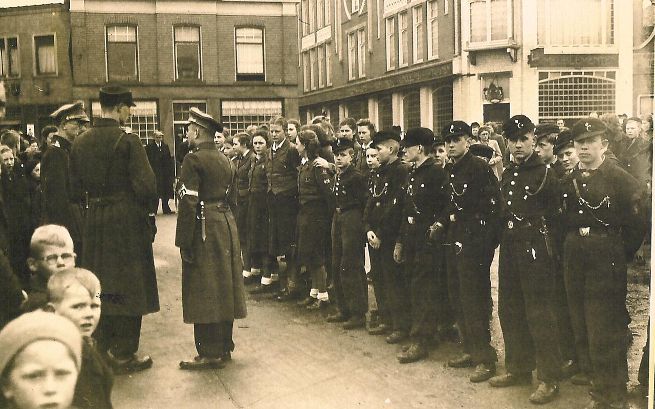 Duitse officieren (links) en leden van de Nationale Jeugdstorm (de Nederlandse versie van de Hitlerjugend) op de Markt in Coevorden, rond 1941. Rechts op de achtergrond het pand van Kardol.