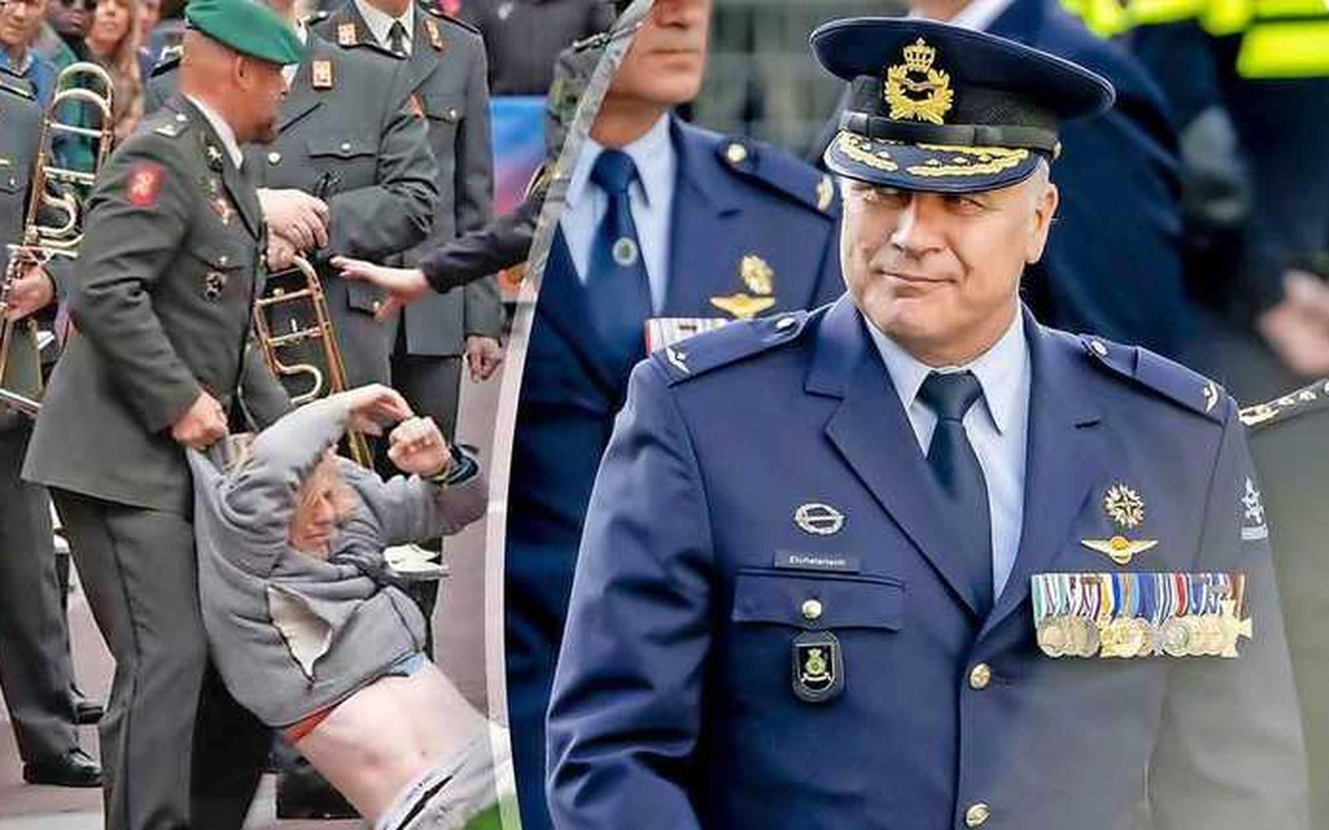 Marco Kroon sleept een demonstrant weg. Rechts: Commandant der Strijdkrachten Onno Eichelsheim.