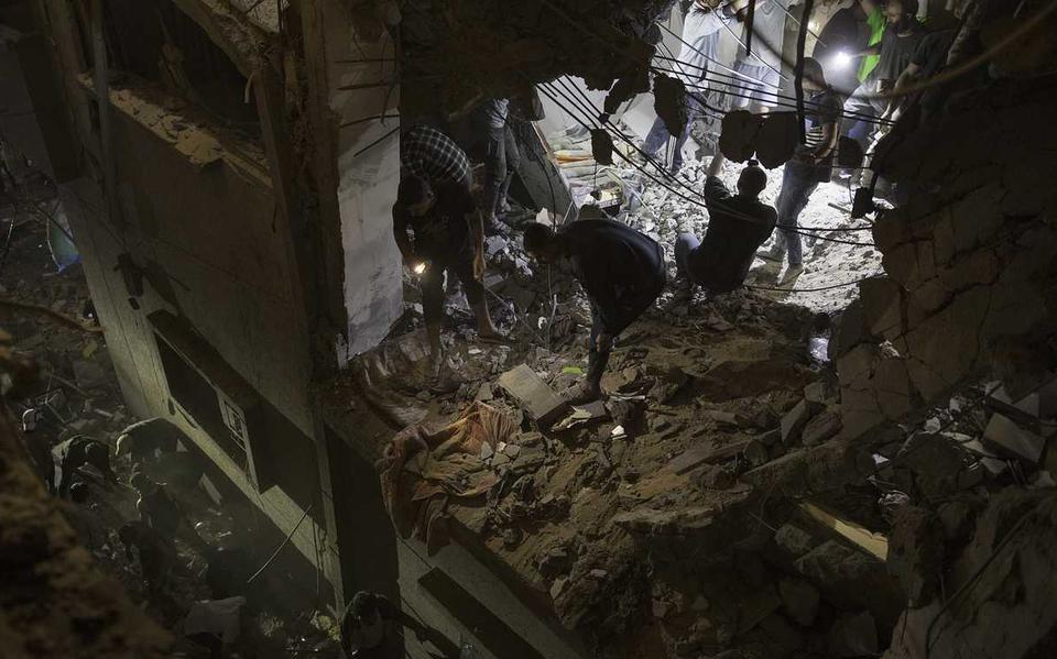 Palestijnen zoeken naar overlevenden na een Israëlische luchtaanval in Rafah.