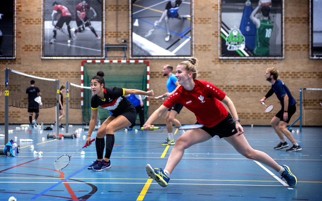 Bianca Oosterhaven (rood shirt) en Jamie Logt in actie tijdens een training van badmintonclub Amor.