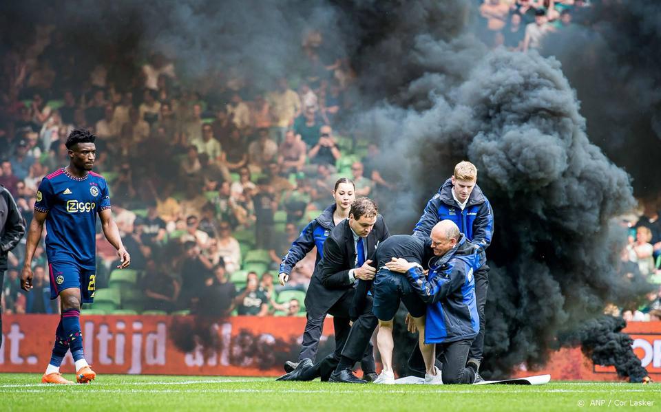 De veldbestormer bij FC Groningen - Ajax wordt neergehaald door beveiligers.
