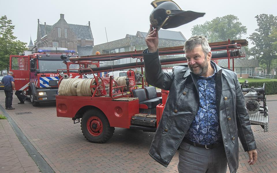 Bert Bouwmeester in een brandweerauto op weg naar het gemeentehuis. 