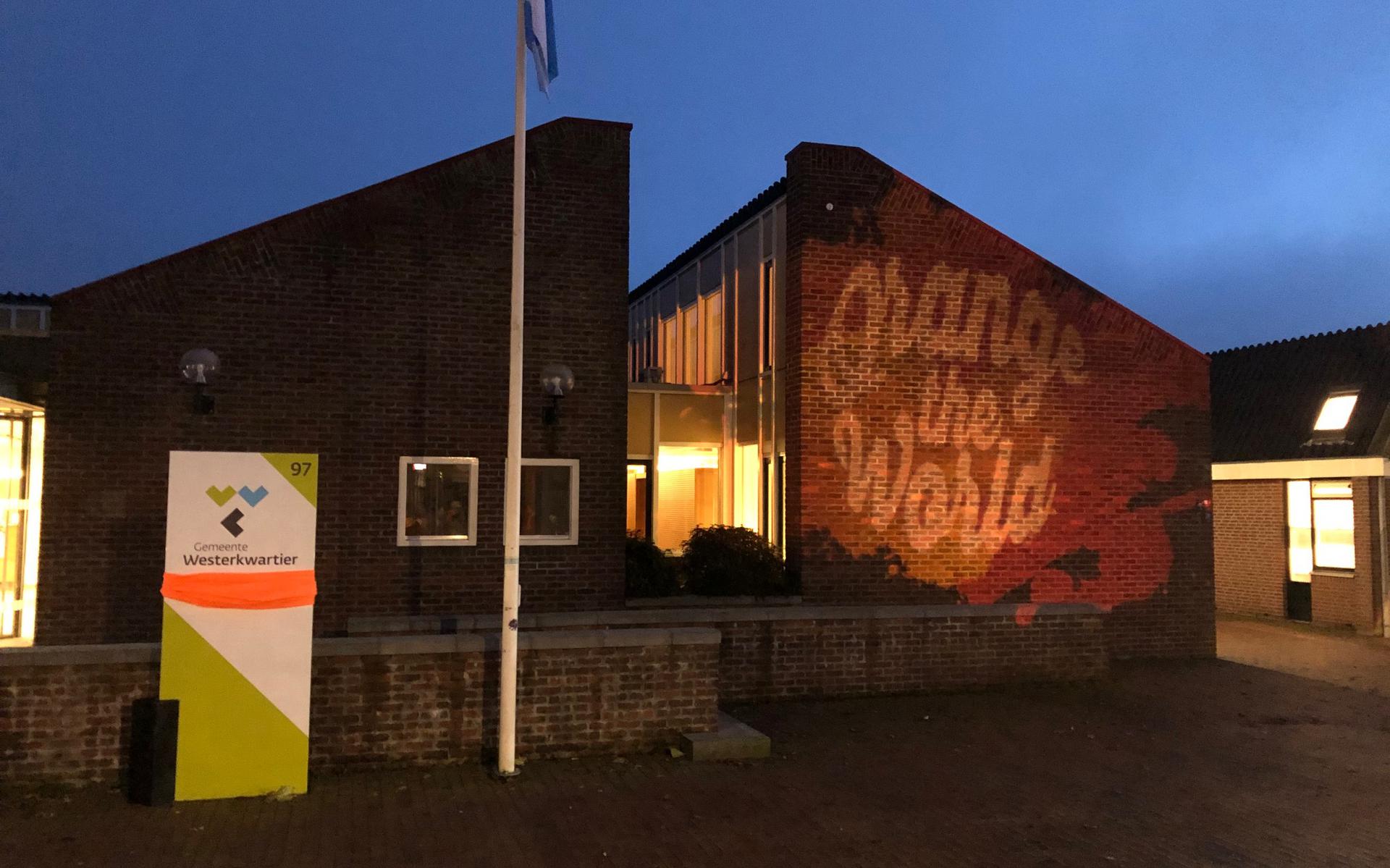 Het logo van 'Orange the World' op het gemeentehuis in Grootegast.