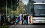 Afghaanse vluchtelingen vertrekken uit de opvang in Zoutkamp en gaan per bus op weg naar Harskamp. 