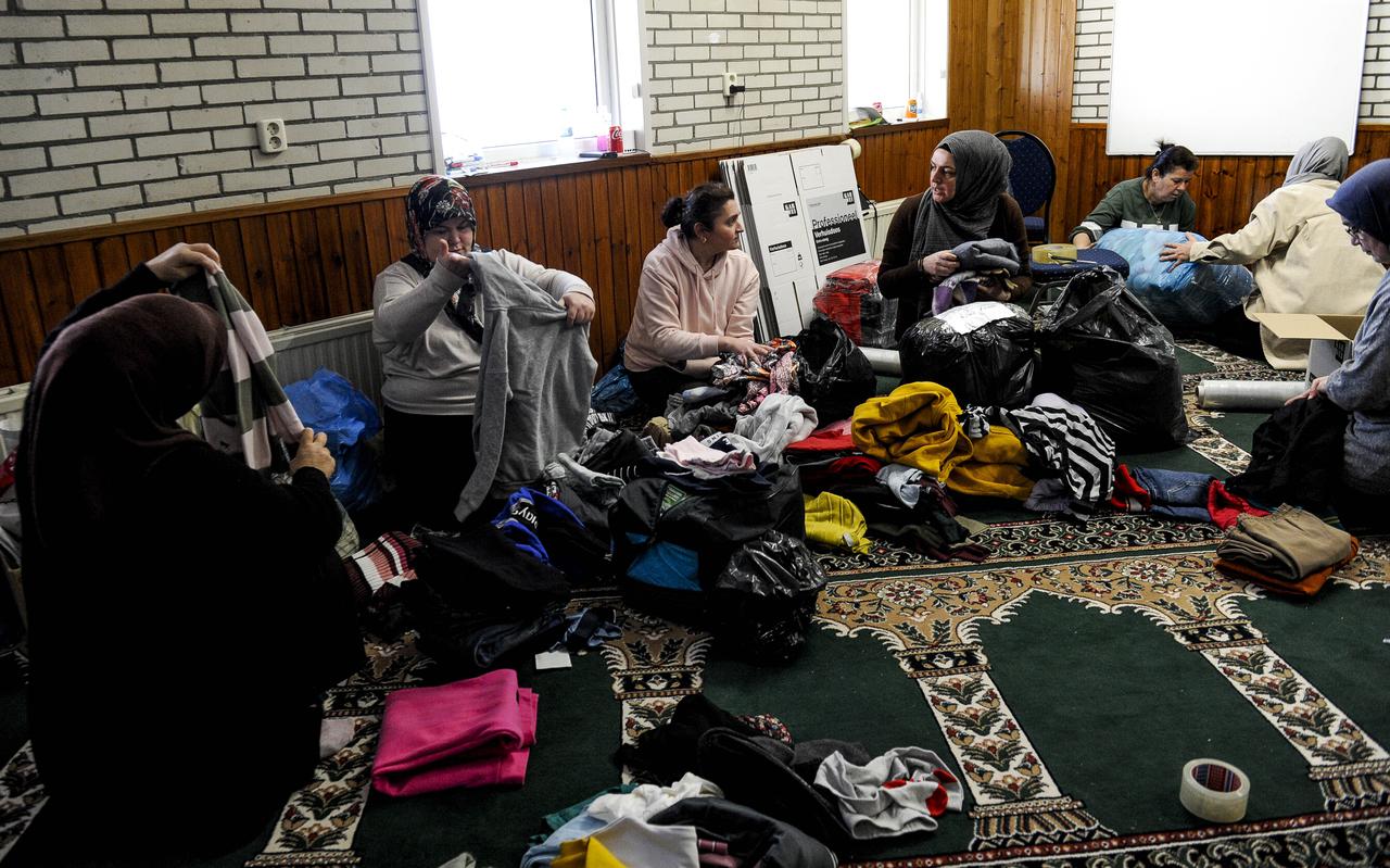 Vrouwen zijn in de moskee in Hoogezand druk bezig met selecteren van kleding voor de Inzamelingsactie voor de aardbevingsramp in Turkije.