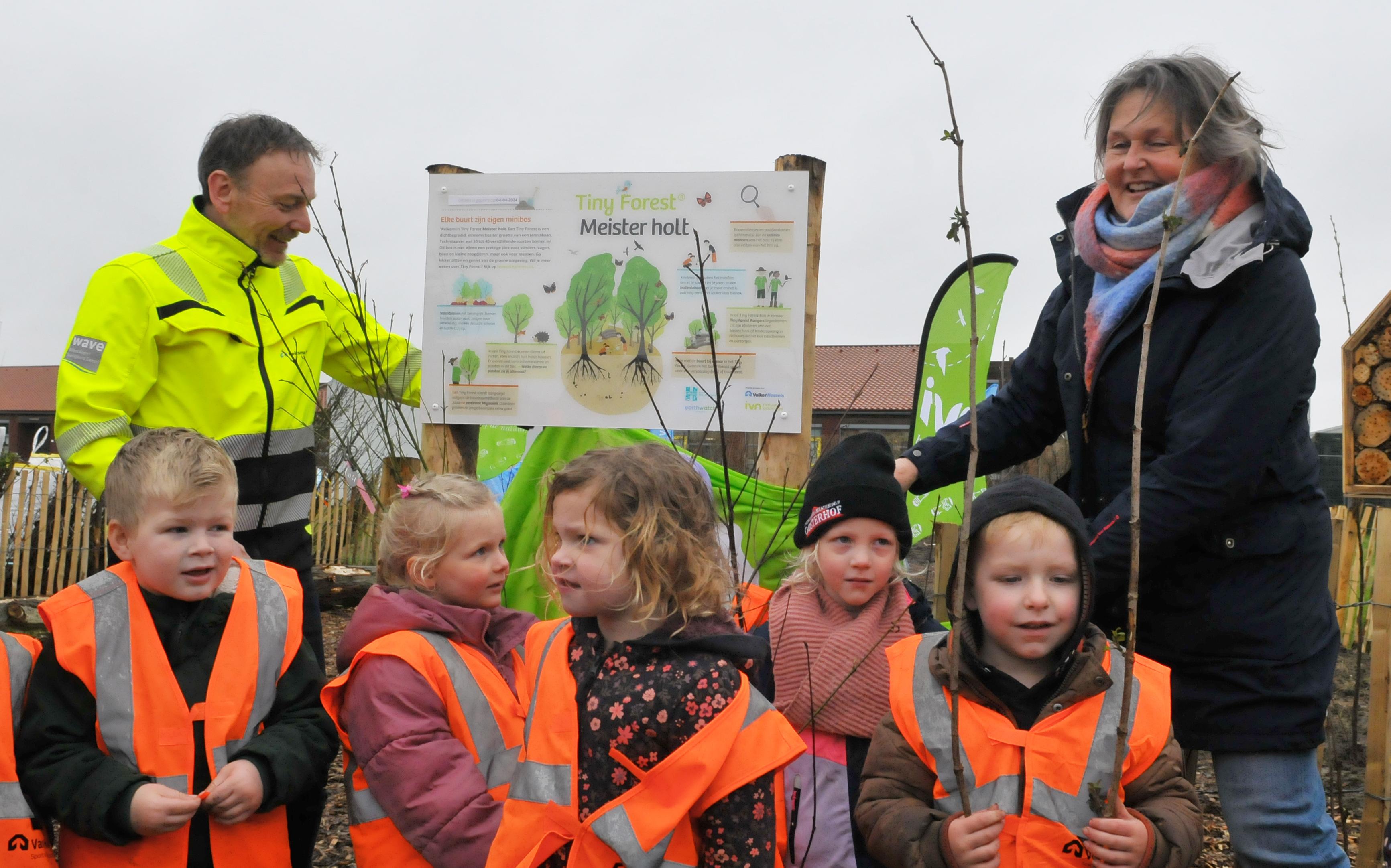 Leerlingen planten met wethouder Karin Hansems eerste bomen tiny forest in Uithuizermeeden