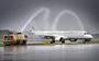 Het toestel van German Airways landt voor de eerste keer op Eelde, de luchthavenbrandweer verwelkomt het met de traditionele waterboog.                                                                                                                                                                                                                                  
