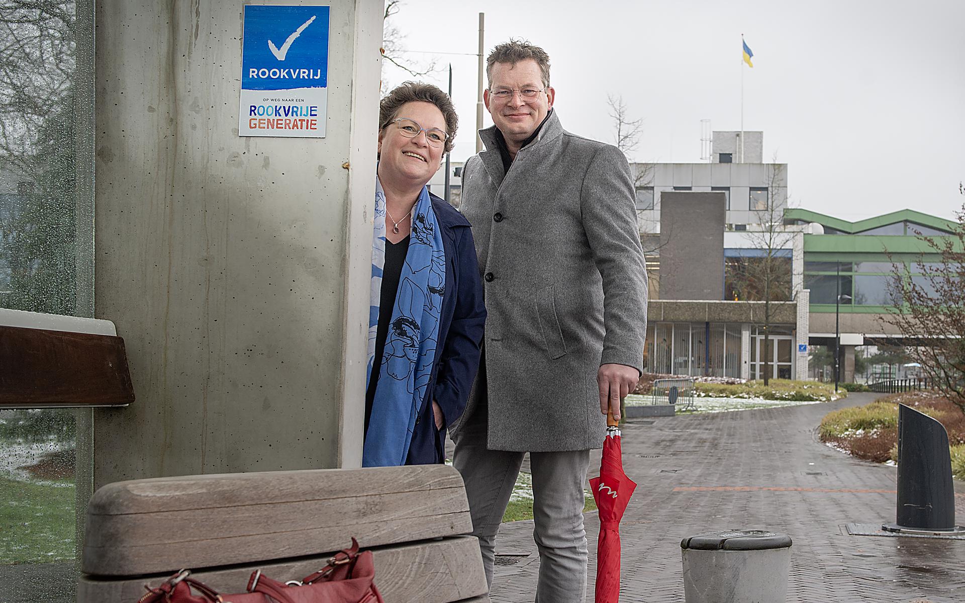 De Drentse gedeputeerde Nelleke Vedelaar en de Emmer wethouder Raymond Wanders bij de eerste rookvrije bushalte in Drenthe. De abri staat in het centrum van Emmen.