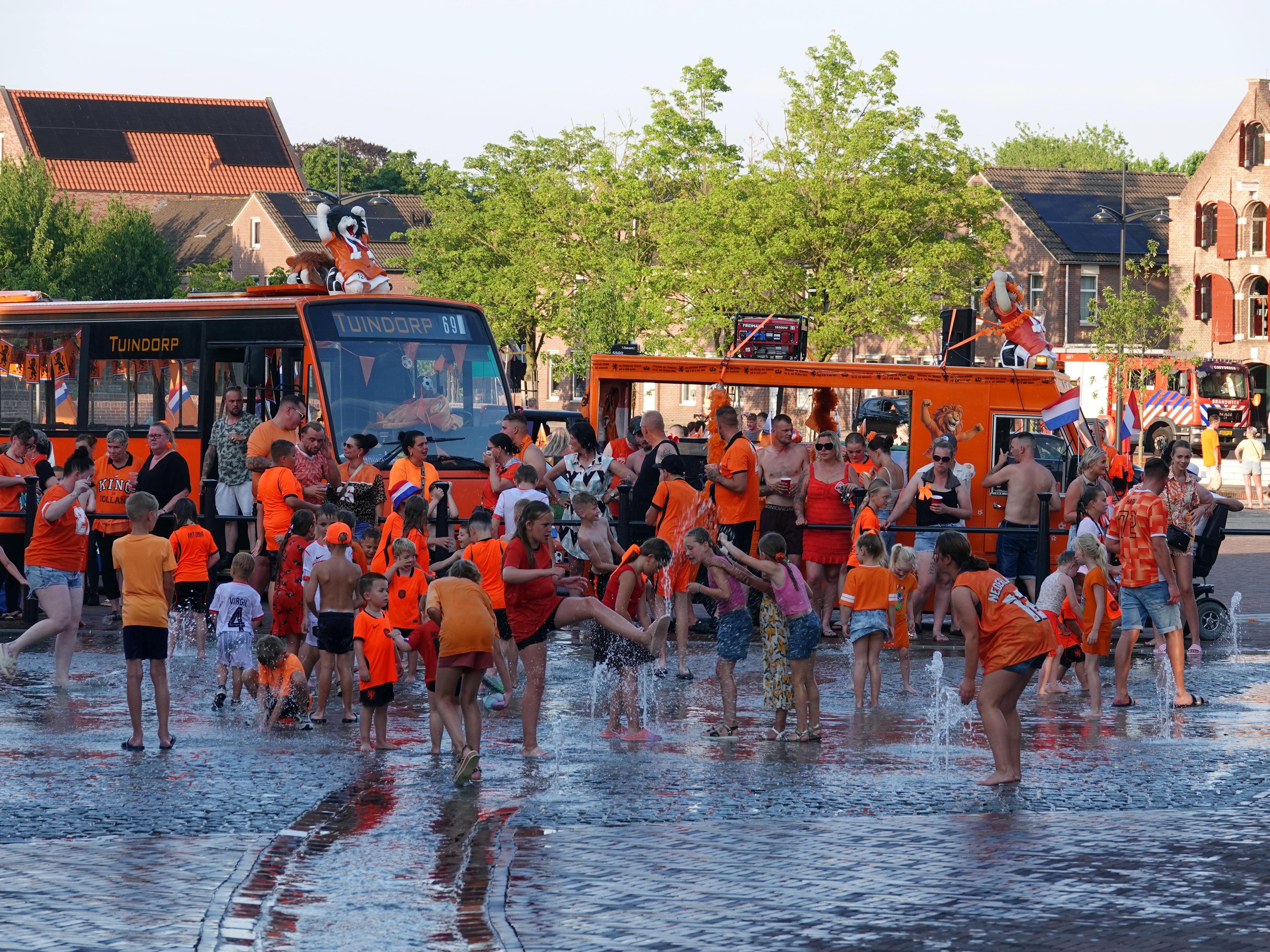 Oranjefans uit Tuindorp vieren feest op Markt in Coevorden. Kinderen genieten van het water